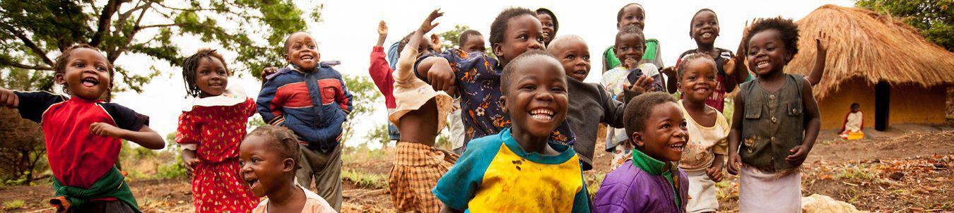 Group of smiling African children playing outside.