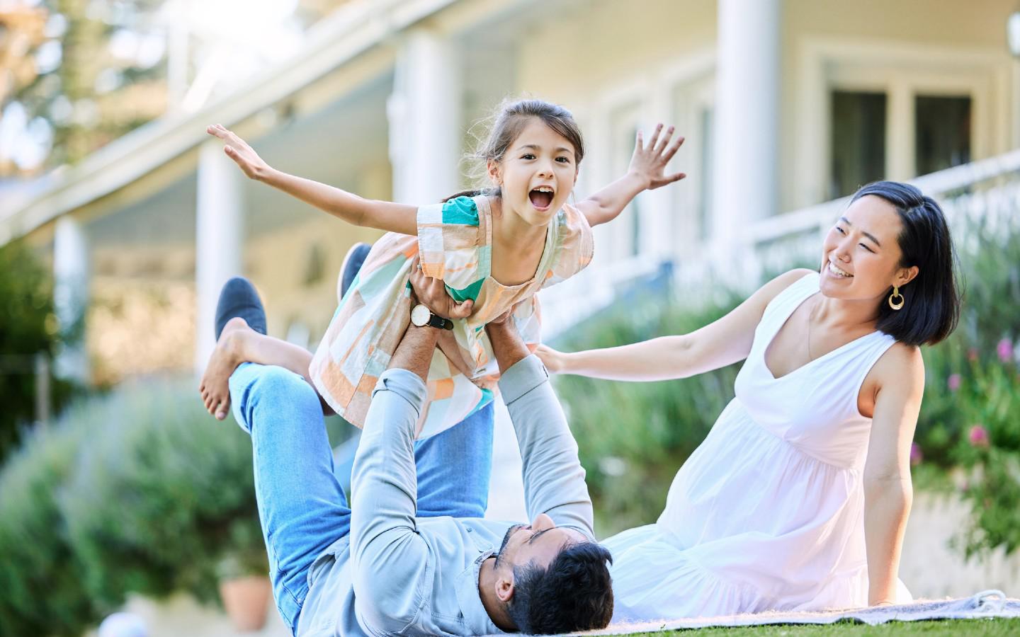 A person and person playing with a child